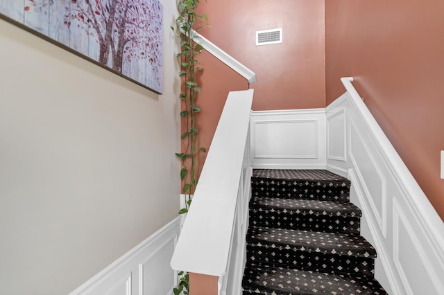2574 Golf Ridge Cir, Naperville, IL 60563 - stairway featuring wainscoting, visible vents, and a decorative wall