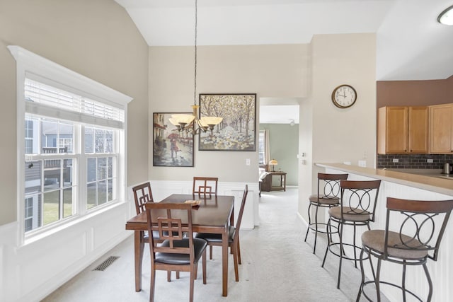 2574 Golf Ridge Cir, Naperville, IL 60563 - dining space with an inviting chandelier, light colored carpet, and a healthy amount of sunlight