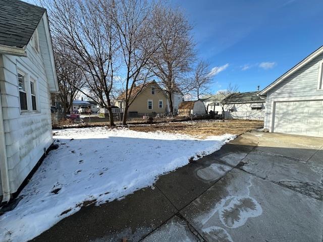 snowy yard with a garage