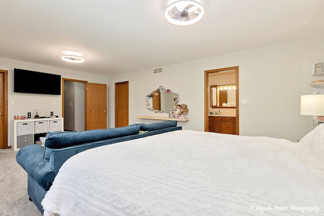 carpeted bedroom with ensuite bathroom