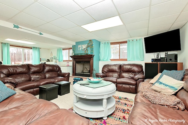 living room with a drop ceiling and plenty of natural light