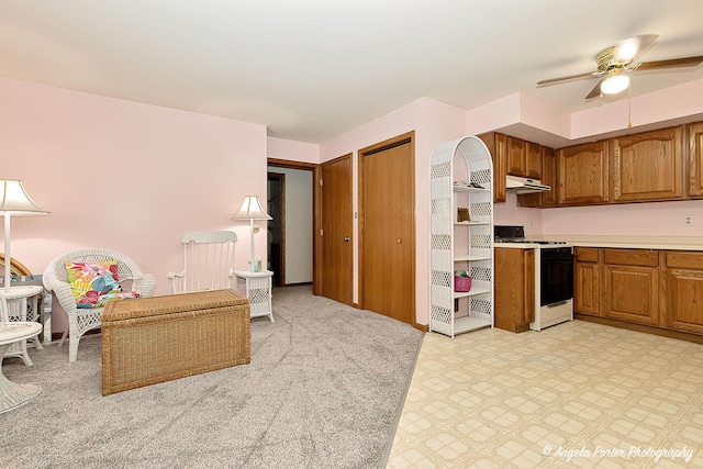 kitchen featuring gas stove and ceiling fan