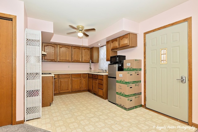 kitchen with ceiling fan and sink