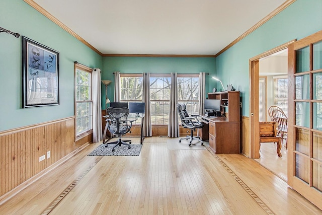 office featuring crown molding, wooden walls, and light hardwood / wood-style floors