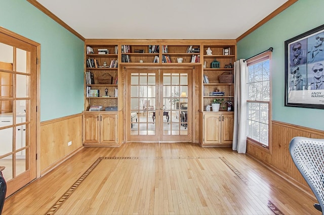 interior space featuring crown molding, built in features, and french doors