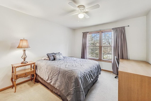 bedroom with ceiling fan and light carpet