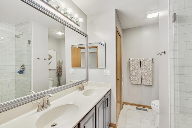 bathroom with vanity, an enclosed shower, and toilet