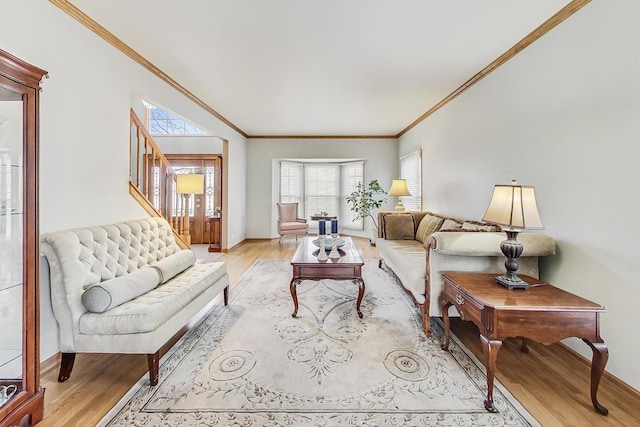 living room featuring ornamental molding and light hardwood / wood-style floors