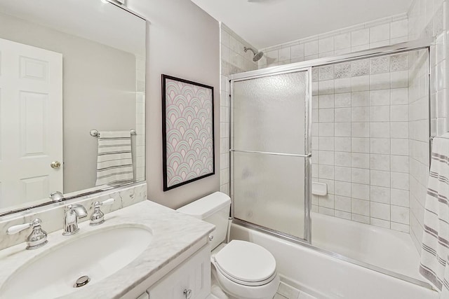 full bathroom with vanity, combined bath / shower with glass door, and toilet