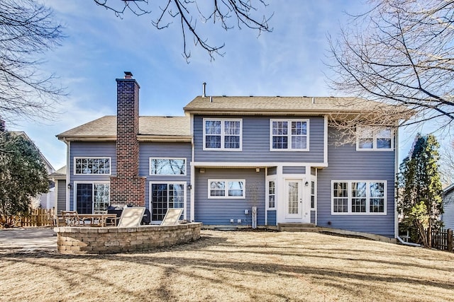 back of property with a yard and a patio area