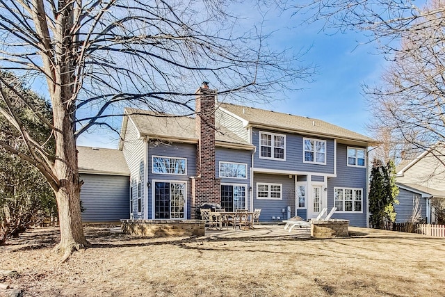 rear view of property featuring a patio and a yard