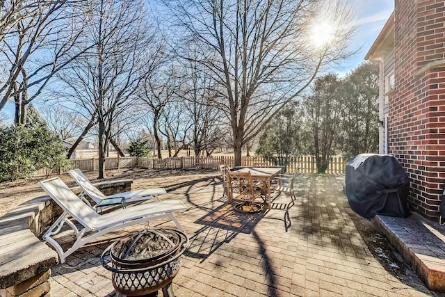 view of patio with a grill and a fire pit