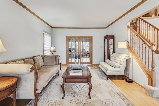 living room featuring hardwood / wood-style flooring, crown molding, and french doors