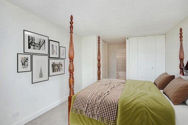 bedroom with light carpet, a textured ceiling, and a closet