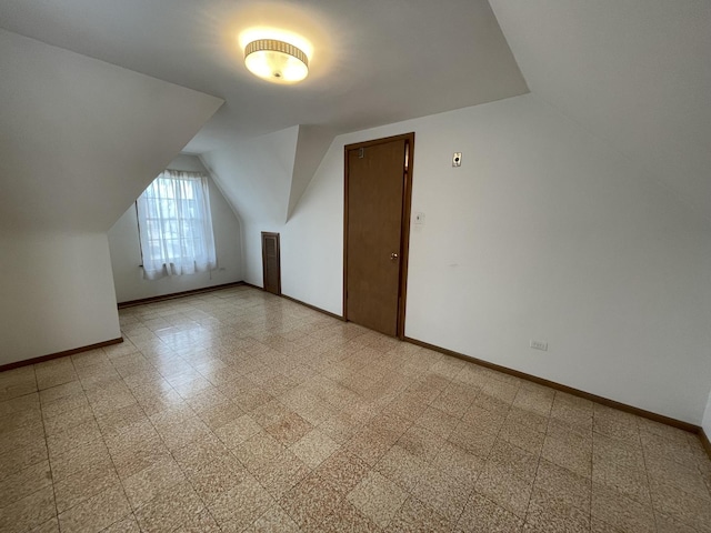 additional living space with vaulted ceiling