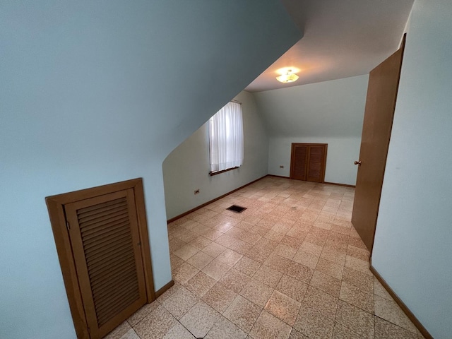 additional living space featuring vaulted ceiling