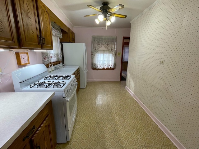 kitchen featuring sink, white appliances, ornamental molding, and ceiling fan