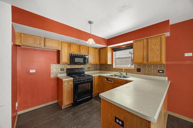 kitchen featuring sink, tasteful backsplash, hanging light fixtures, kitchen peninsula, and black appliances