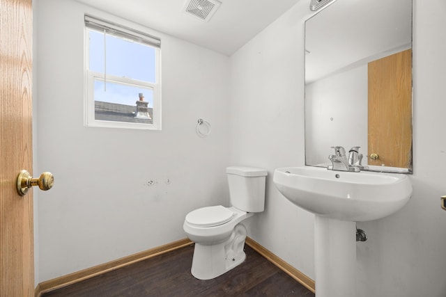 bathroom featuring hardwood / wood-style floors and toilet