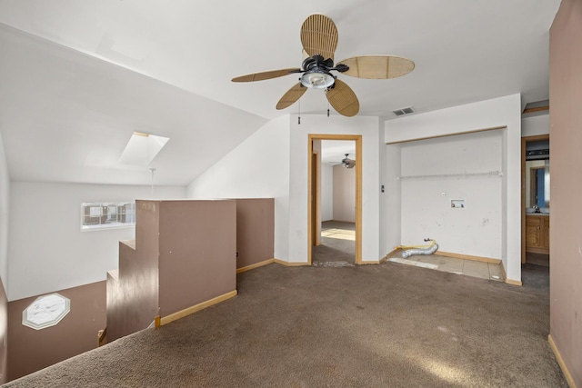 bonus room featuring carpet floors, vaulted ceiling with skylight, and ceiling fan