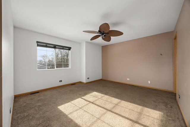 unfurnished room featuring ceiling fan and carpet flooring