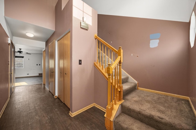 stairs with hardwood / wood-style flooring and ceiling fan