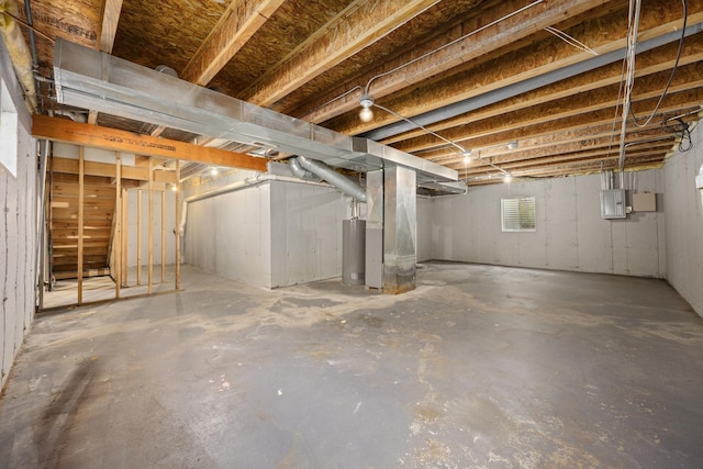 basement featuring gas water heater and electric panel