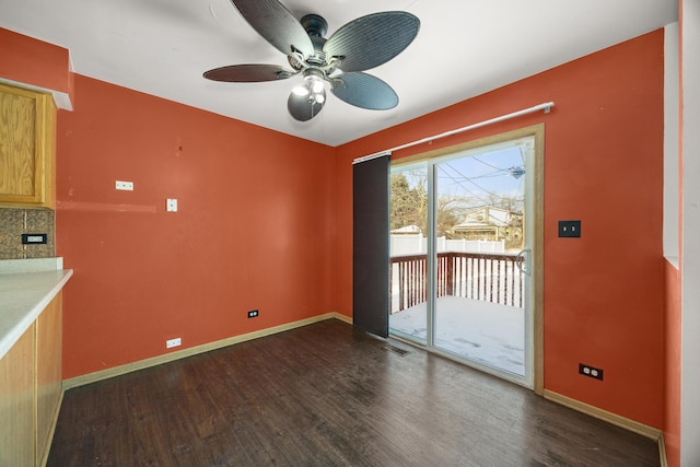 unfurnished dining area featuring dark hardwood / wood-style flooring and ceiling fan