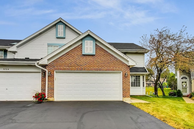 front of property featuring a garage and a front lawn