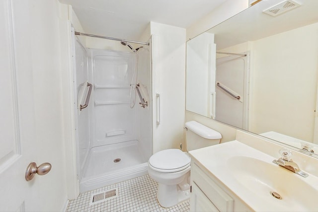 bathroom with tile patterned flooring, toilet, vanity, and walk in shower