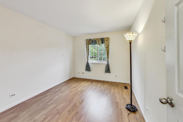 spare room featuring light wood-type flooring