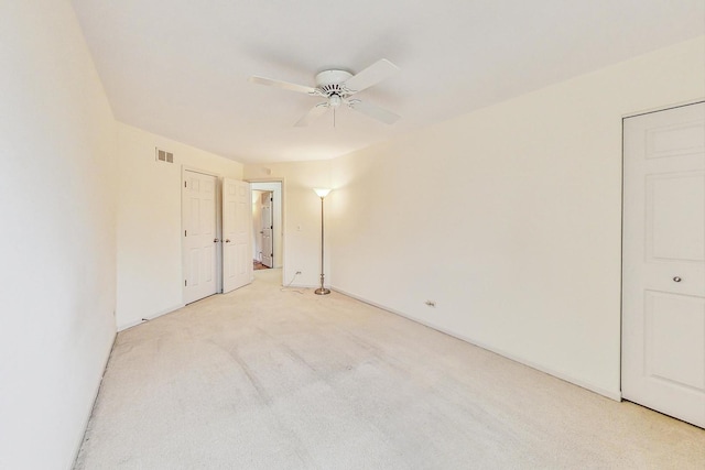 unfurnished bedroom with light colored carpet and ceiling fan