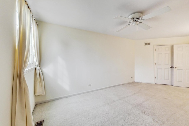 carpeted empty room featuring ceiling fan