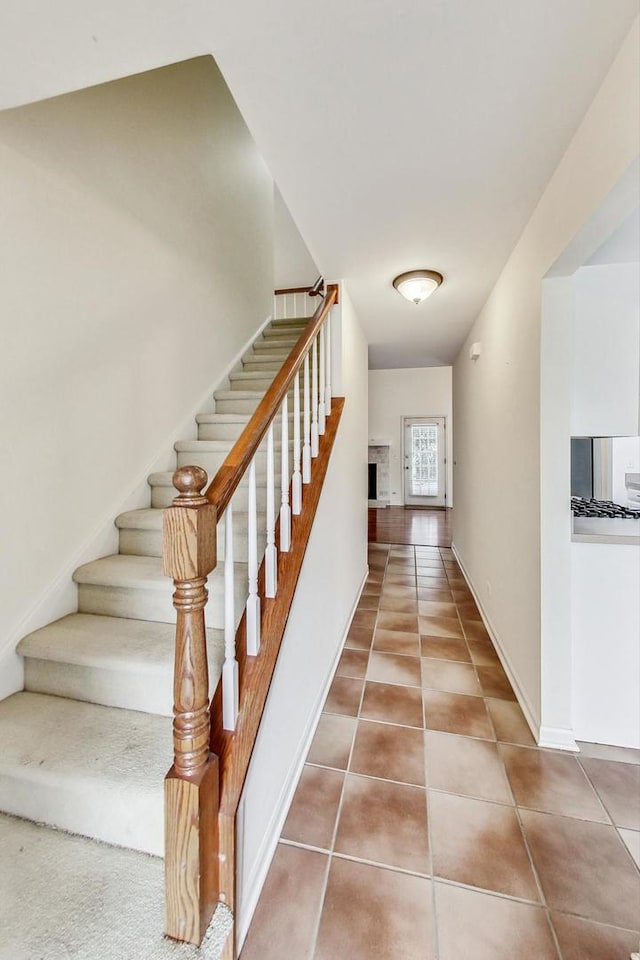 staircase with tile patterned floors