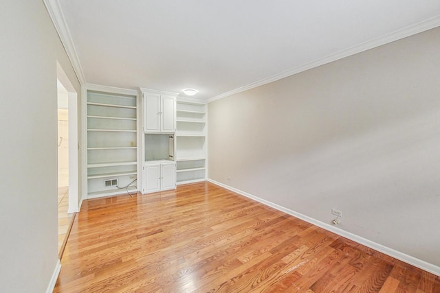 interior space featuring ornamental molding and light hardwood / wood-style floors