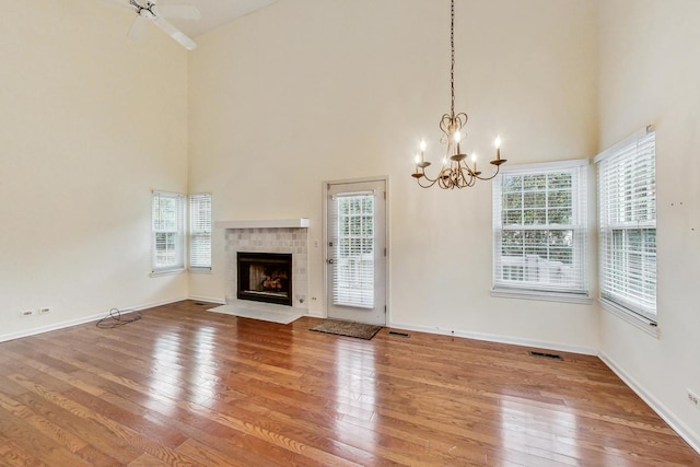 unfurnished living room featuring plenty of natural light, hardwood / wood-style floors, and a fireplace