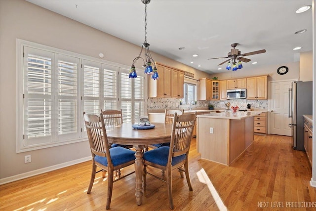 dining area featuring light hardwood / wood-style flooring and ceiling fan