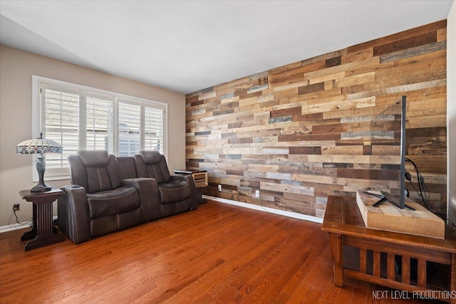 living room featuring wood-type flooring and wood walls