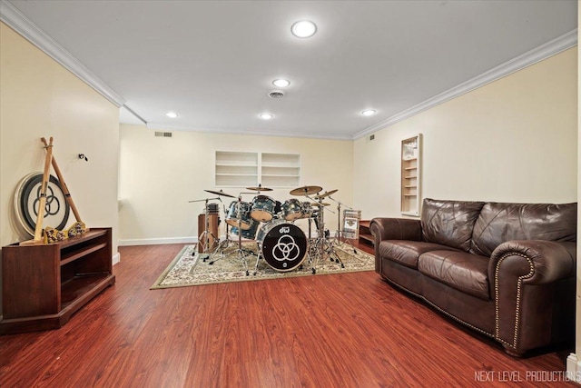 living room featuring crown molding, dark wood-type flooring, and built in features