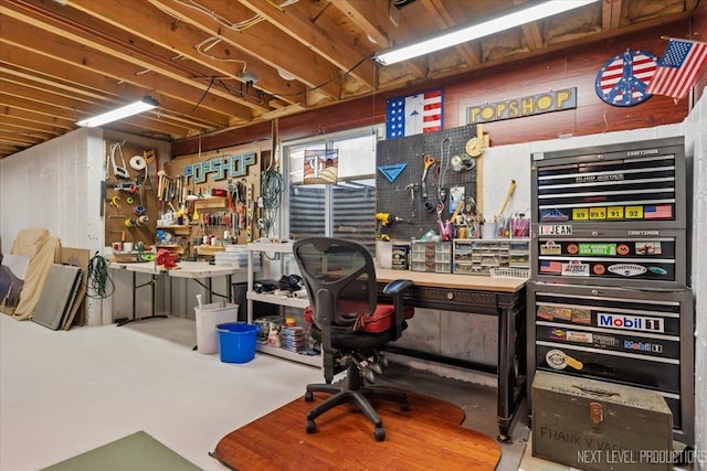 office area with a workshop area and concrete floors