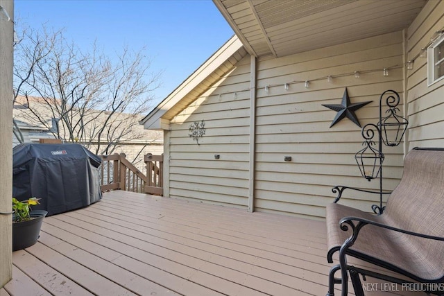 wooden terrace featuring area for grilling