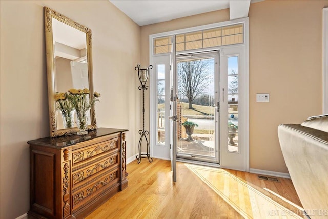 doorway with light hardwood / wood-style flooring