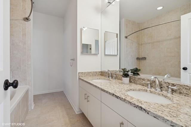 bathroom with vanity, tile patterned floors, and tiled shower / bath