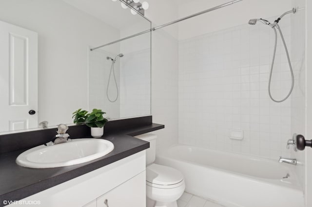 full bathroom with vanity, tiled shower / bath, tile patterned floors, and toilet