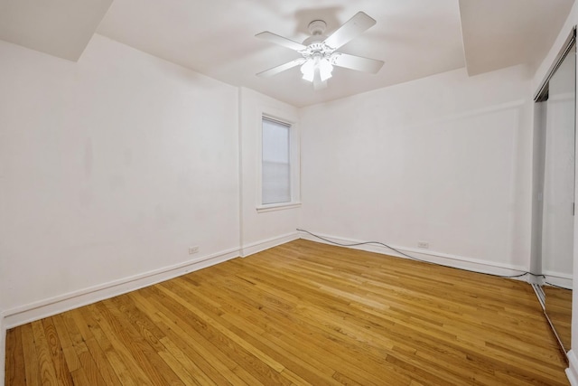 empty room with wood-type flooring and ceiling fan