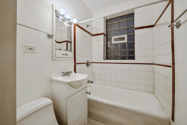 full bathroom with vanity, tiled shower / bath, and toilet