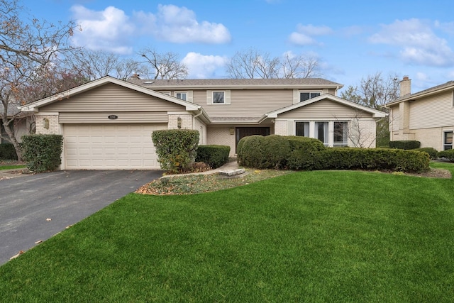 front facade featuring a garage and a front yard