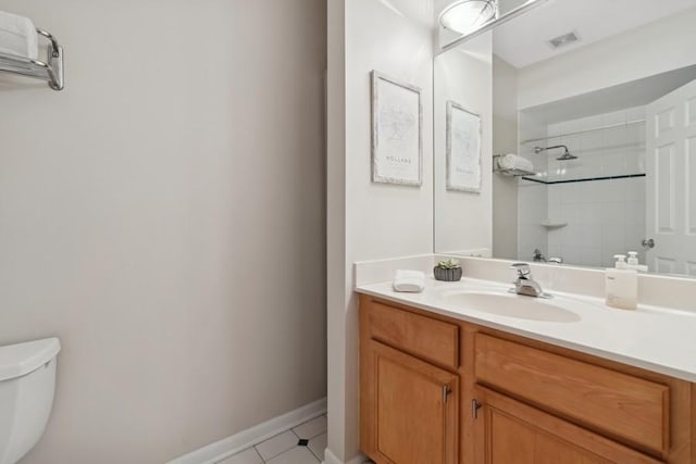 bathroom featuring vanity, tile patterned floors, and toilet