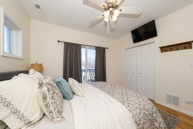 bedroom with wood-type flooring, a closet, and ceiling fan