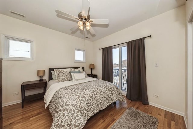 bedroom featuring access to exterior, wood-type flooring, and ceiling fan